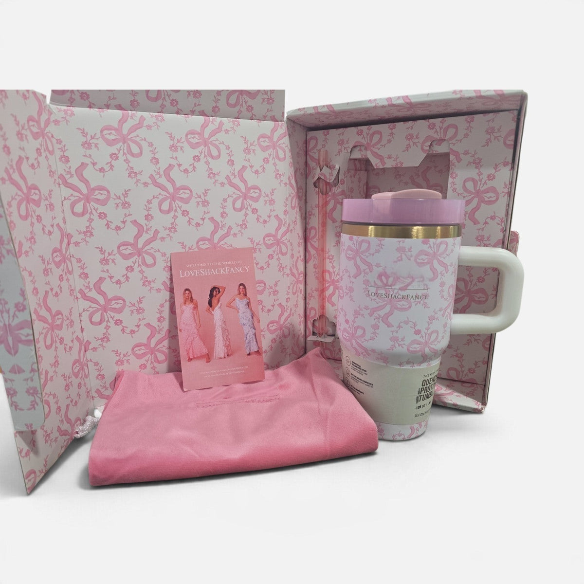 NCHIMBA LoveShackFancy stainless steel tumbler gift set with pink floral ribbon motif, straw, and carrying pouch.